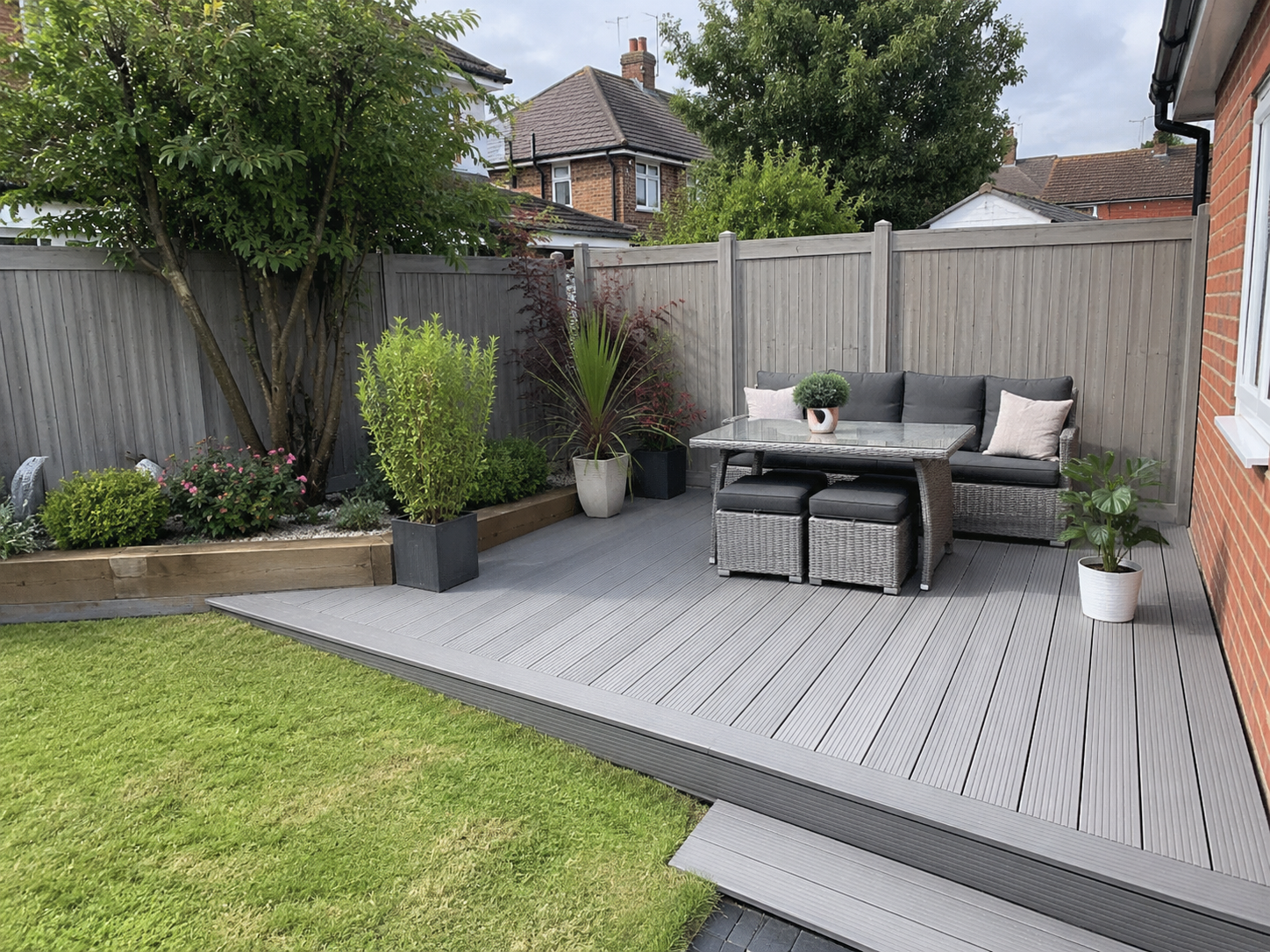 Composite decking bordered by matching grey fence panels
