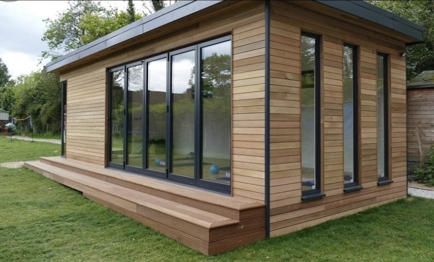 Timber-clad garden room with hardwood decking and bifold doors